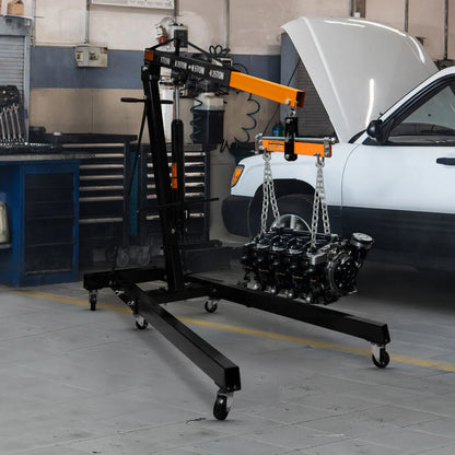 Engine hoist with a car engine on it in a garage setting